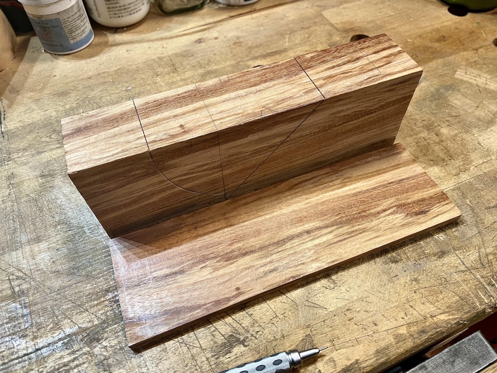 A wooden block with the sides cut off and resting beside it.