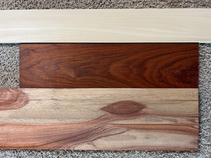 Three uncut boards of poplar and padauk.