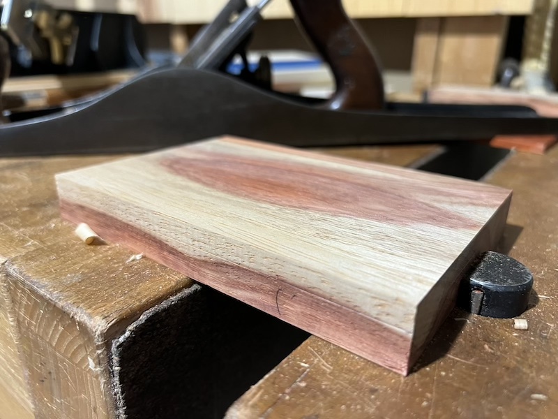 A piece of padauk clamped in the vise.